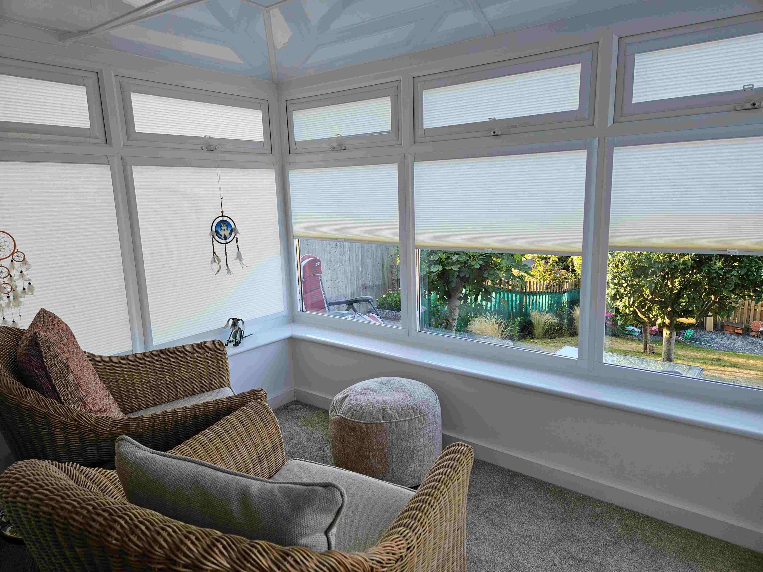 Pleated conservatory blinds partially lowered for light and glare control